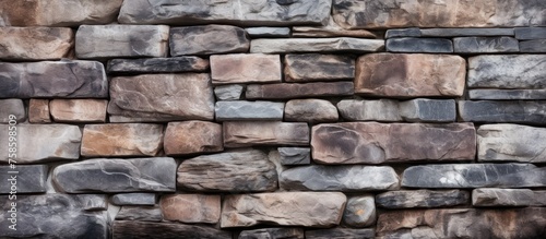 A detailed closeup photo showcasing a diverse mix of brown bricks in a brick wall. The combination of different types of bricks creates a unique and varied texture