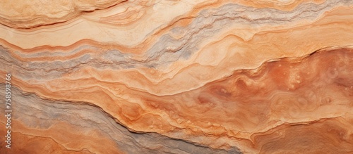 A detailed close up of a brown marble texture with a swirling pattern, resembling natural amber wood. This unique ingredient can add a touch of elegance to any dish or flooring design © AkuAku