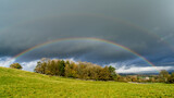 Double rainbows and cloudy sky in autumn