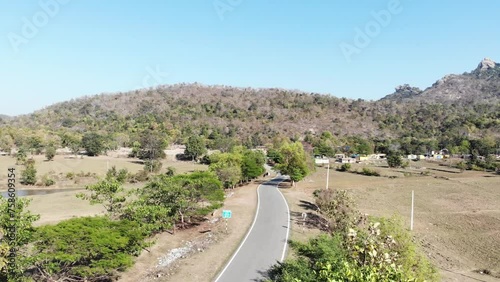 Aerial shot of beautiful village and a concrete road passing from the middle of the village in Charu, Chatra, Jharkhand, India. photo