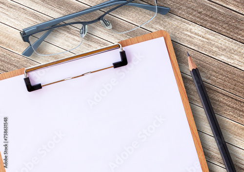 Medical clipboard and glasses with pencil