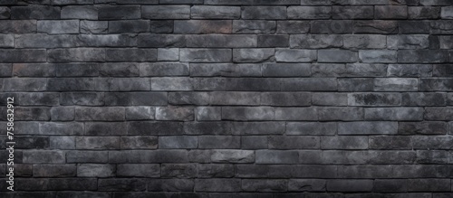 A detailed monochrome photograph capturing the intricate pattern of grey brickwork  showcasing the composite material and rectangular shape of the black brick wall