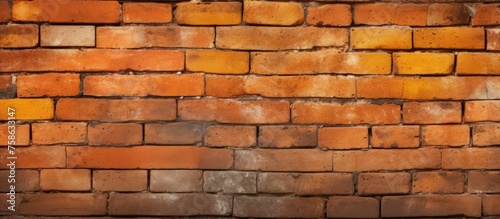 A detailed closeup of a brown brick wall showcasing the rectangular bricks, durable building material made from composite material
