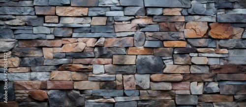 An intricate closeup of a brick wall showcasing a variety of building materials such as rocks, creating a beautiful composite artwork in a rectangular formation