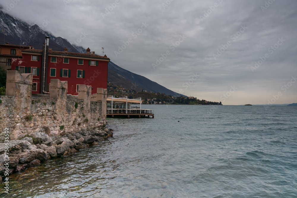 View from the Malcesine pier across the water front and the lake during Autumn with no tourists