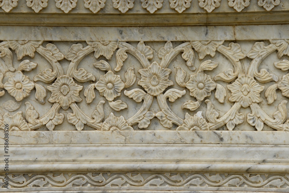 Intricately Carved Stone Frieze on medieval  cenotaph Wall in Broad Daylight at maharani ki chhatri Jaipur, Rajasthan, India 
