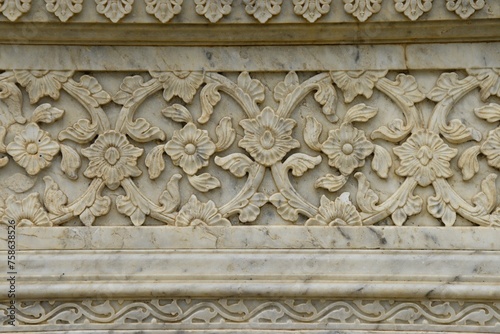 Intricately Carved Stone Frieze on medieval cenotaph Wall in Broad Daylight at maharani ki chhatri Jaipur, Rajasthan, India 