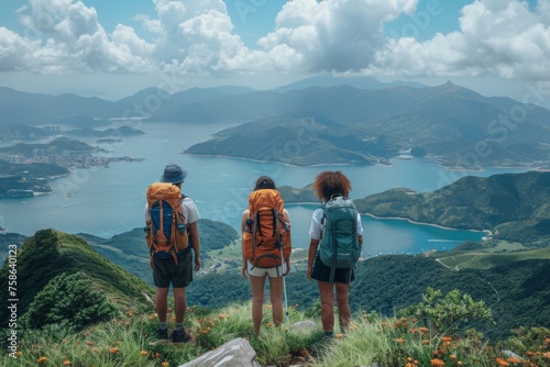 Travelers overlook a stunning seascape from a mountain peak. photo