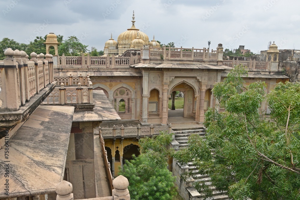 Fototapeta premium Majestic Royal Cenotaphs Amidst Verdant Greenery Under Cloudy Skies at Maharani Ki Chhatri ,Jaipur, Rajasthan, India