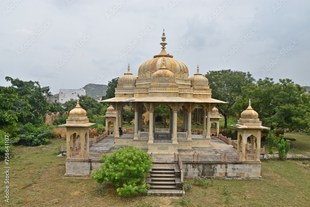 Majestic Royal Cenotaphs Amidst Verdant Greenery Under Cloudy Skies at Maharani Ki Chhatri ,Jaipur, Rajasthan, India