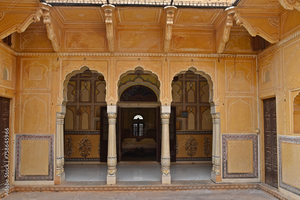 A sequence of intricately designed arched doorways open to a tranquil courtyard, Nahargarh Fort, Jaipur, Rajasthan, India 