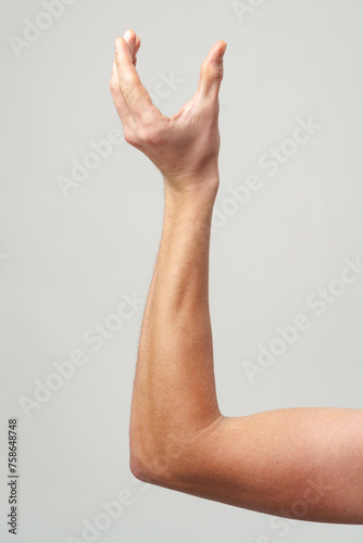 Male hand gestures over gray background studio shot