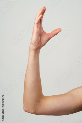 Male hand gestures over gray background studio shot