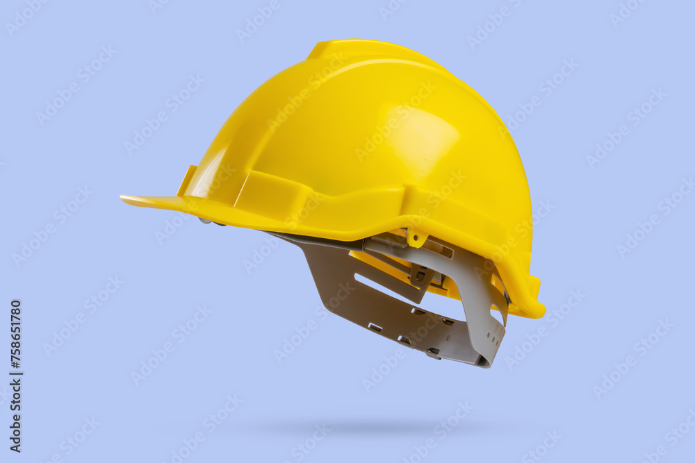 Yellow safety construction helmet on blue background