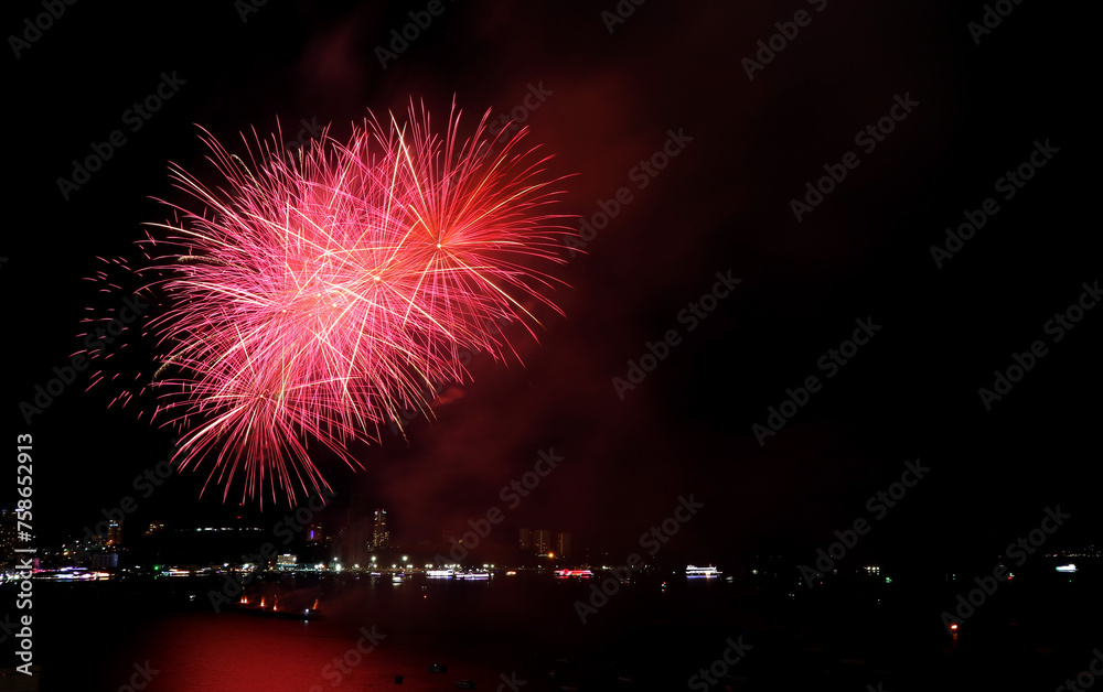 Fantastic fireworks splashing in the night sky over the city harbor Fantastic fireworks splashing in the night sky over the city harbor