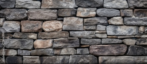 A detailed closeup of a rectangular stone wall constructed with various rocks, showcasing a beautiful pattern of different building materials