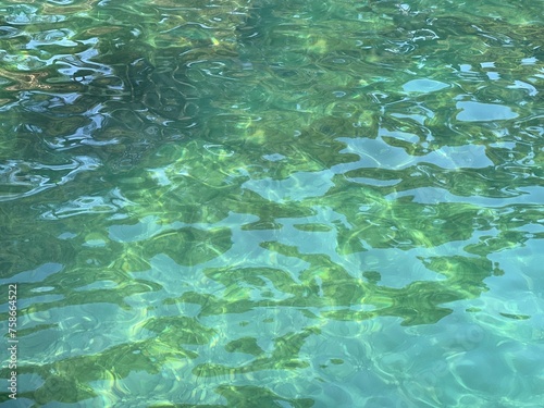Sea clear green blue water background. © OLENA