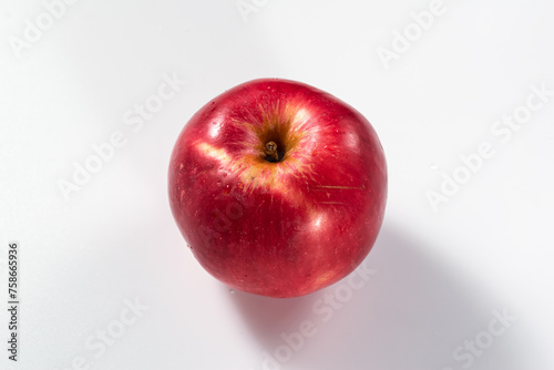 Isolated single red apple on a white background. View from above at an angle