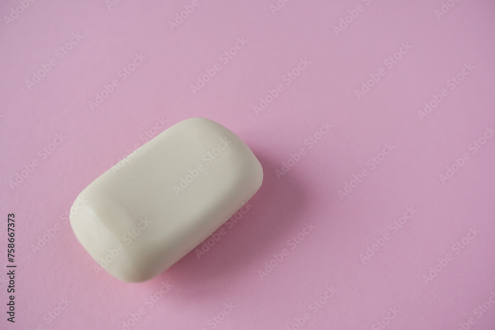 White soap bar on pink background. Minimal style. Top view. White soap bar on pink background. Minimal style. Top view.