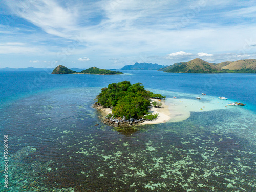 Beautiful panorama view of CYC Beach. Group of boats floating over the clear water and corals. Coron, Palawan. Philippines.