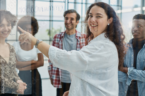 business woman with her staff in background at office