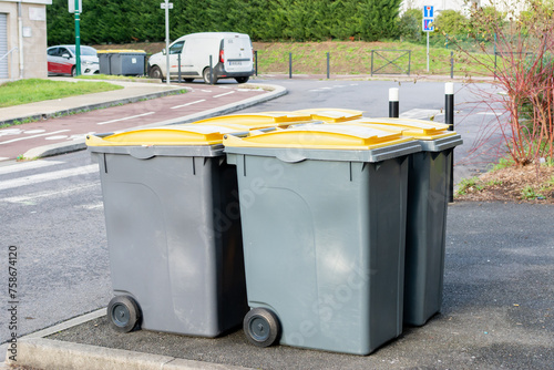 Poubelles d'immeubles sur un trottoir photo