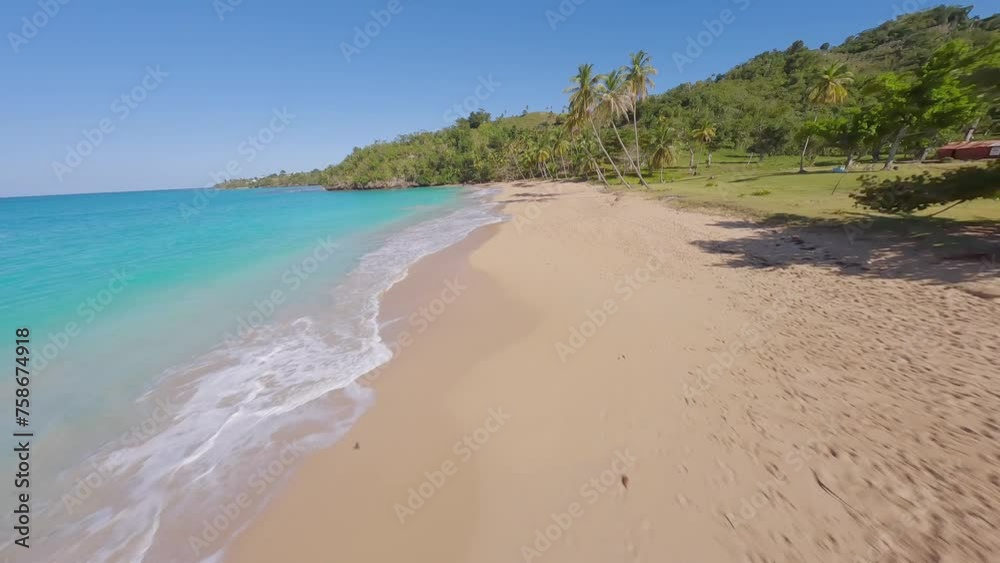 Aerial flyover sandy beach with Caribbean sea and tropical palm trees at sunny day. FPV forward flight. Aerial flyover sandy beach with Caribbean sea and tropical palm trees at sunny day. FPV forward flight.
