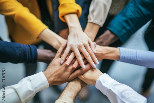 Diverse group of businesspeople stacking hands together in unity