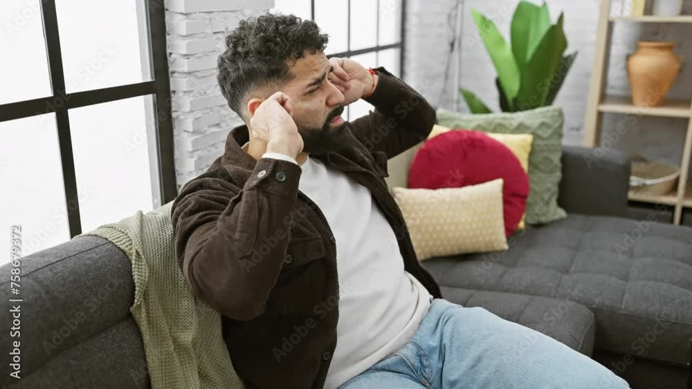 Annoyed young man at home, covering ears with fingers due to loud music noise, expressing deaf pain. stressful indoor silence problem. Annoyed young man at home, covering ears with fingers due to loud music noise, expressing deaf pain. stressful indoor silence problem.