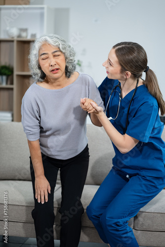 Professional physiotherapist taking care of asian senior patient during rehabilitation.