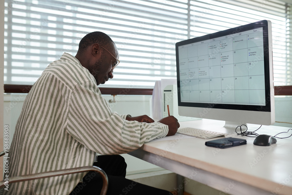 Office manager checking schedule and filling planner Office manager checking schedule and filling planner