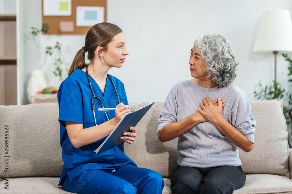 © NanSan - Caucasian teenager female doctor consults with and Asian elderly patient on medical history, discussing headaches, chest pain, coughing, sneezing, stomach pain, and neck pain while seated on a sofa. © NanSan - Caucasian teenager female doctor consults with and Asian elderly patient on medical history, discussing headaches, chest pain, coughing, sneezing, stomach pain, and neck pain while seated on a sofa.