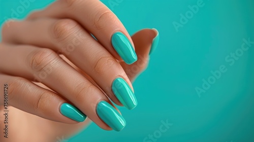 Turquoise manicure on a woman's hand.
