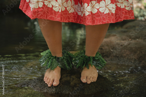 Closeup detail of bare feet of a graceful young lady dancing Hawaiian dance outdoors in the natural rainforest. Concept of Pacific island culture. Sensation of exoticism and mystery.