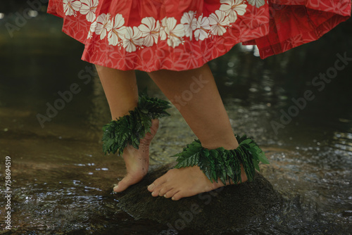 Closeup detail of bare feet of a young irl dancing Tahitian dance outdoors in the wild jungle. Concept of traditional Pacific dances. Sensation of vitality and energy.