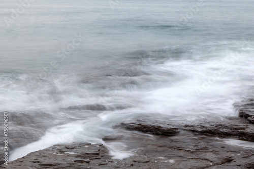 Long-exposure view of the surf at the seaside photo