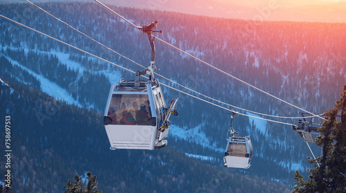 Banner ski lift resort in winter, Aerial top view Sheregesh, forest landscape on mountain with sunset light, Kemerovo region Russia