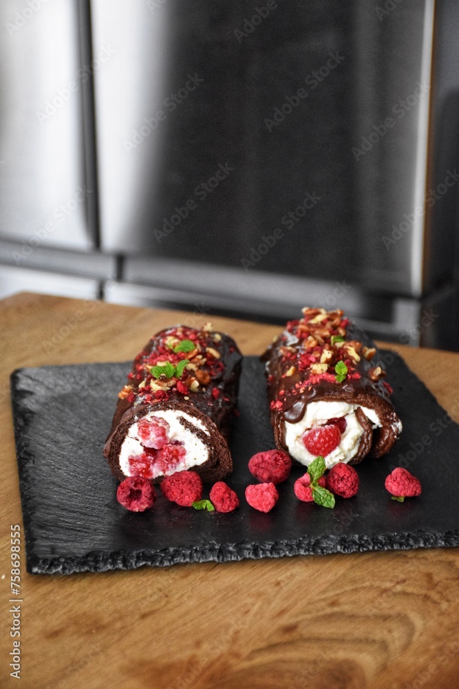 Sweet chocolate roll with whipped cream and raspberries Sweet chocolate roll with whipped cream and raspberries