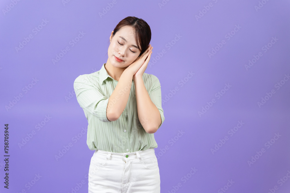 Photo of young Asian woman on purple background Photo of young Asian woman on purple background
