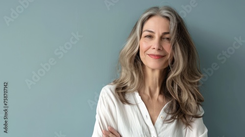 Beautiful middle-aged woman with gray hair in a white shirt