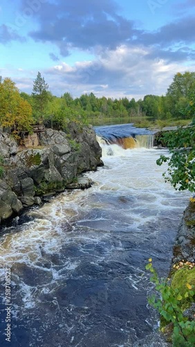 Voytsky padun waterfall in autumn. The famous powerful and wide Karelian waterfall Voytsky Padun is surrounded by rocks and greenery. Cascading waterfall on the river. Karelia, Russia 4K photo