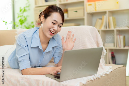 Photo of young Asian woman at home