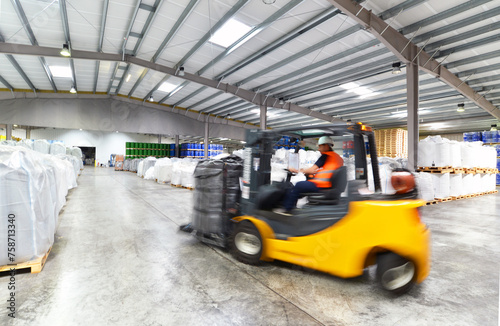 forklift driver in a logistics hall of a chemical warehouse © industrieblick
