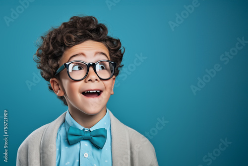 A little boy of about 7 or 8 years old looking up with great excitement at something surprising he has seen photo