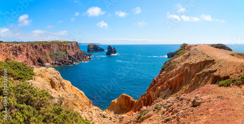 rocky coast landscape portugal, with cliffs and atlantic view, green conifers
