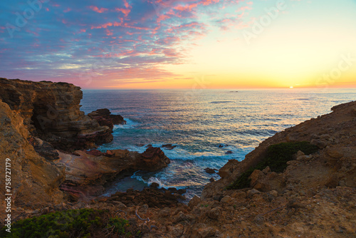 sinking sun over atlantic ocean algarve, rocky cliffs carrapateira portugal landscape