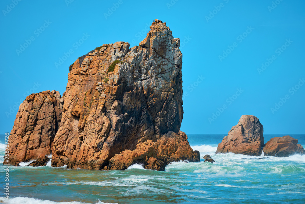 Landscape of the sea with waves and large stones and mountains