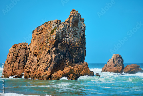 Landscape of the sea with waves and large stones and mountains