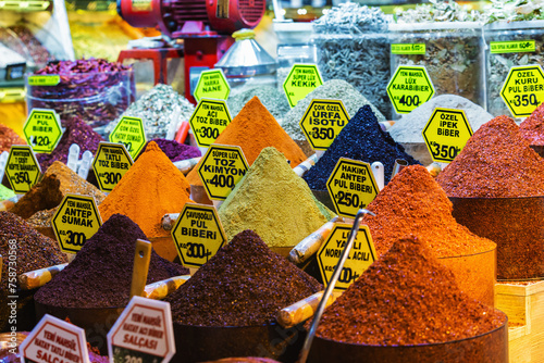 Colorful Turkish spice bazaar heaps, aromatic allure, in bold, natural hues. Egypt bazaar in Istanbul. Names of spices in Turkish language on labels photo