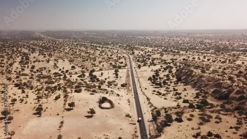 Aerial view of road with cars running trough it in Thar desert, Sindh, Pakistan.